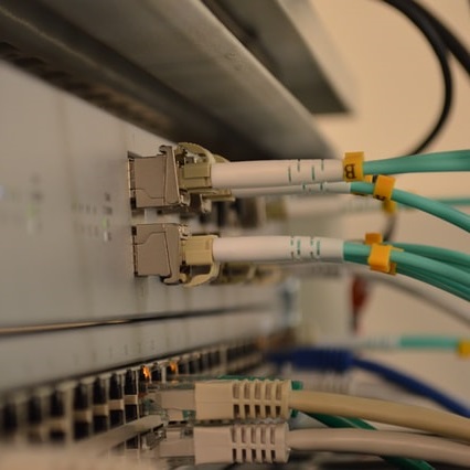 Network switch with fiber cables and CAT6 cables plugged in